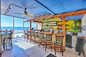 Enjoy ocean views from this beachfront bar with a counter and stools.