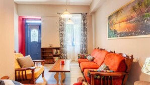 A living room with a sofa set, a coffee table, and a bookshelf.