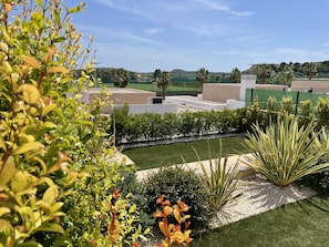 Enjoy the serene atmosphere of this beautifully landscaped outdoor space, featuring lush plants and a tranquil water feature.