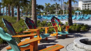 A poolside area with lounge chairs and a pool.