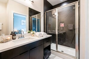 Bathtub, hair dryer, towels, shampoo