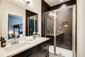 Bathtub, hair dryer, towels, shampoo