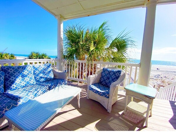 A covered outdoor seating area with wicker furniture and a view of the beach. - ☆Oceanfront Serenity☆ Private Pool & Beach Walkway (Myrtle Beach)