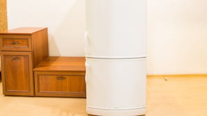 A white refrigerator next to a wooden cabinet with drawers. - DOWNTOWN - Compact Flat  - 2 Separate Rooms (Бургас)