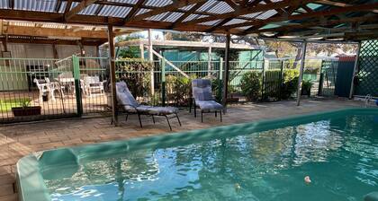 4 or 5 bedroom home with solar heated, undercover outdoor pool. Pet friendly.