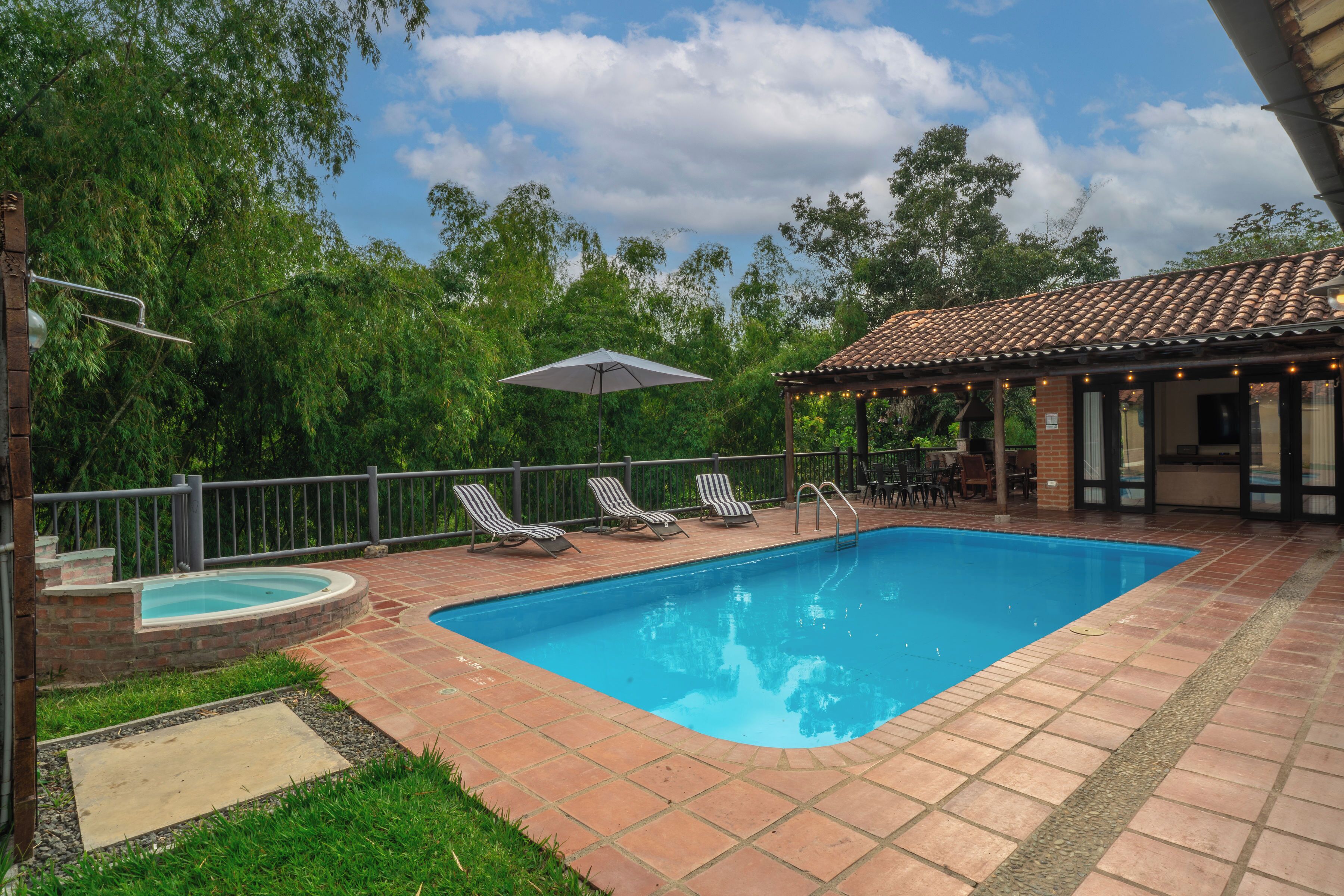 Panoramic view of our pool with loungers and hammock.