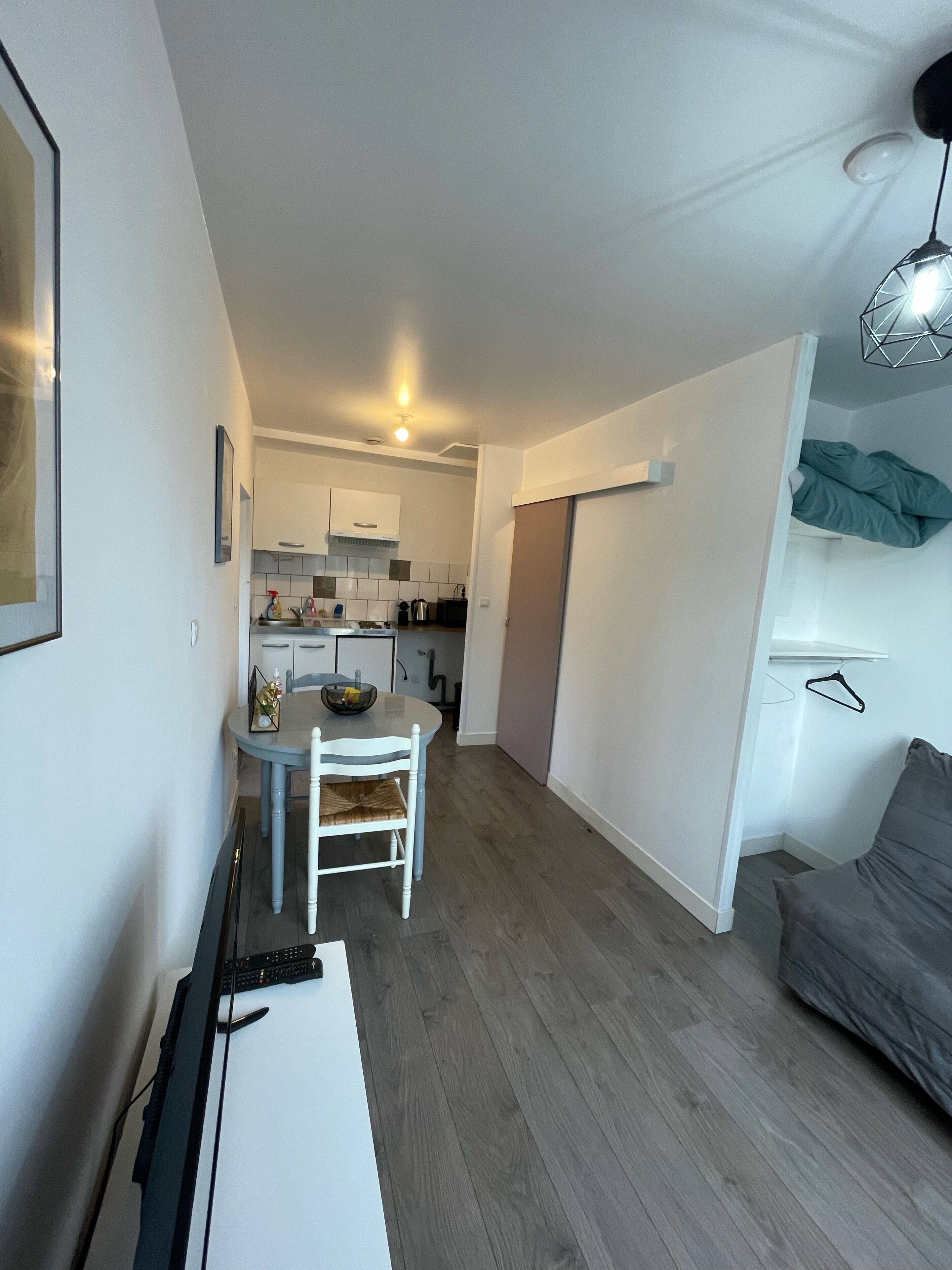 A compact living space with a kitchenette, a dining area, and a seating area.