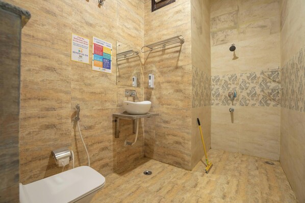 A bathroom with a sink, mirror, towel rack, and shower. - goSTOPS Rishikesh, Lakshman Jhula (Yamkeshwar)