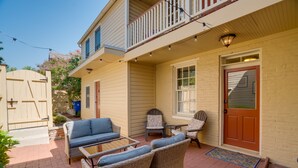 A patio with wicker furniture and a door. - 4 Bedroom, 3  Bath  Big Downtown Frederick home, w/ Private Patio &  fire table (Frederick)