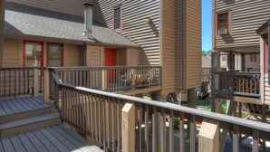 A multi-story residential building with a wooden deck and a small balcony. - Durango Townhome w/ Pool/Hot Tub | Near FLC, Town, Golf & Trails (Durango)