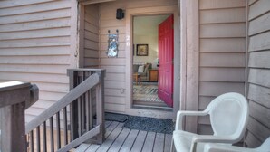 A wooden porch with a red door, a white chair, and a mailbox. - Village View Vista | Walk to Town, Pool/Hot Tub - Near FLC, Golf (Durango)