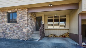 A two-story building with a stone facade and a covered entryway. - Purgatory townhome with Easy Access to Slopes - Views - EV Charger (Durango)