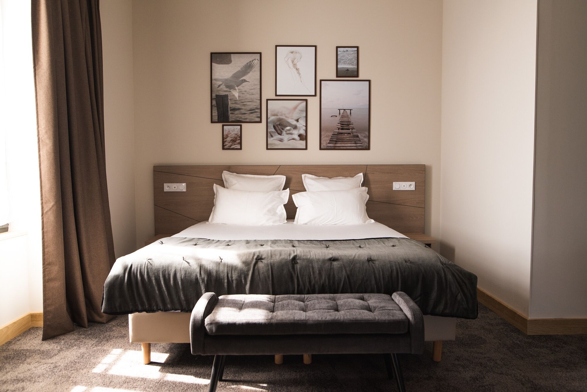 A neatly arranged bedroom with a bed, bedside tables, and a bench.