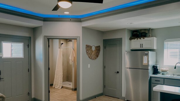 A modern kitchen with a built-in refrigerator and a window. - The Honeymoon Hideaway (Trenton)