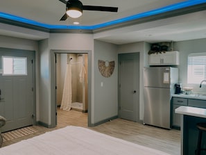 A modern kitchen with a built-in refrigerator and a window. - The Honeymoon Hideaway (Trenton)