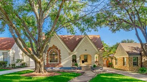 A residential house with a brick facade, a front porch, and a well-maintained lawn. - Kessler Park Retreat - Walking distance to Bishop Arts District  (Dallas)