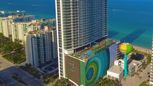 A high-rise hotel with a modern design, featuring a large pool area and a view of the ocean. - BeachFront Luxury Hotel | 3B OceanView Hyde Resort (Hollywood)