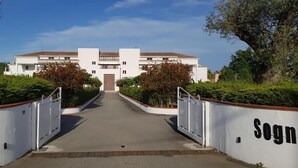 Ein begrenzter Eingang zu einem Gebäude mit einer symmetrischen Fassade und einem zentralen Portal.