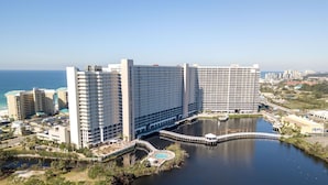 A large hotel with multiple high-rise buildings, a central courtyard, and a body of water. - SMOOTH SAILING-BEAUTIFULLY DECORATED, GULF VIEWS (Panama City Beach)