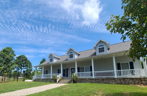 A large country home with scenic views of a working cattle farm & rural locale.