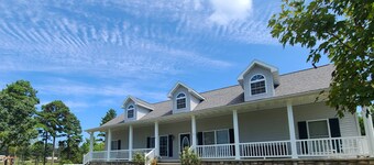 A large country home with scenic views of a working cattle farm & rural locale.