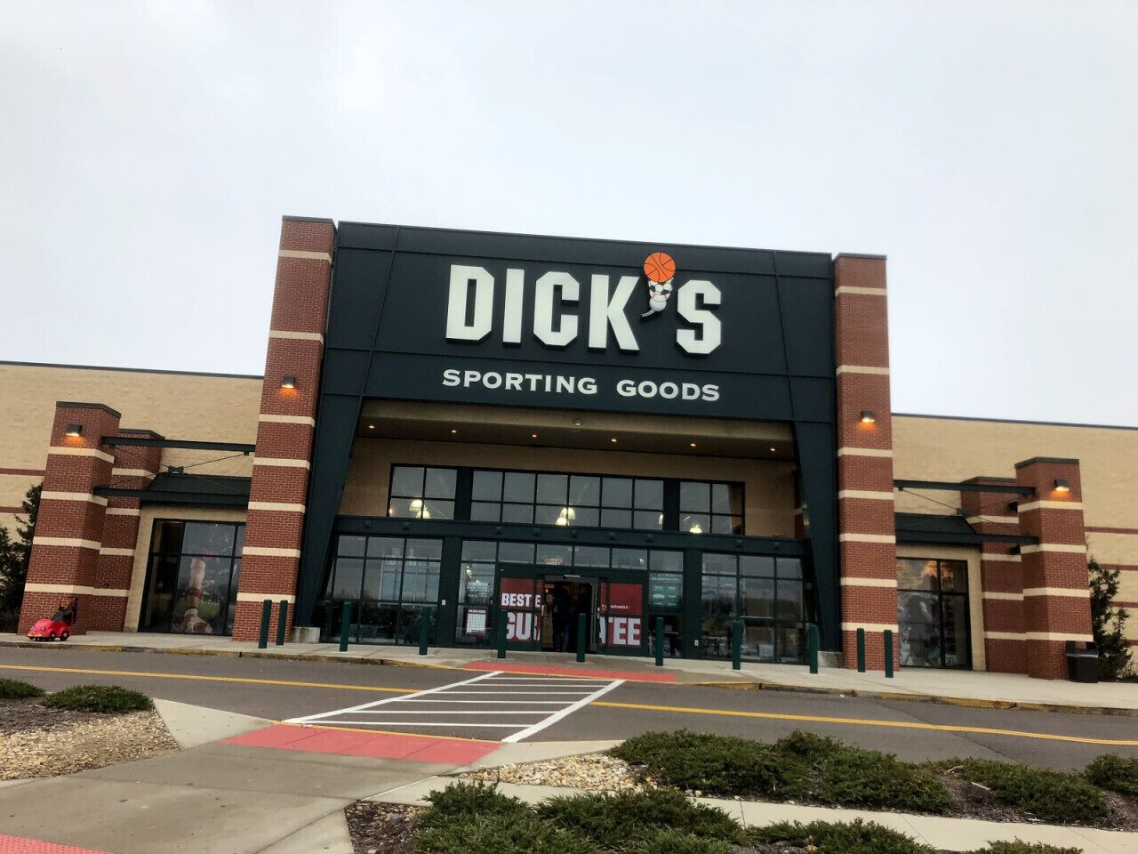 A Dick's Sporting Goods store with a brick facade and large entrance doors.