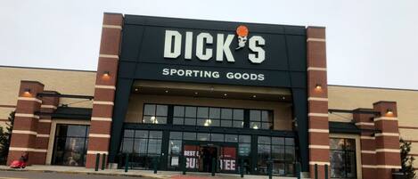 A Dick's Sporting Goods store with a brick facade and large entrance doors.