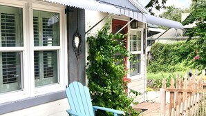 A house with a porch, a blue Adirondack chair, and a wooden fence. - Location! Location! Location! In the middle of Downtown Mt Dora!  (Mount Dora)