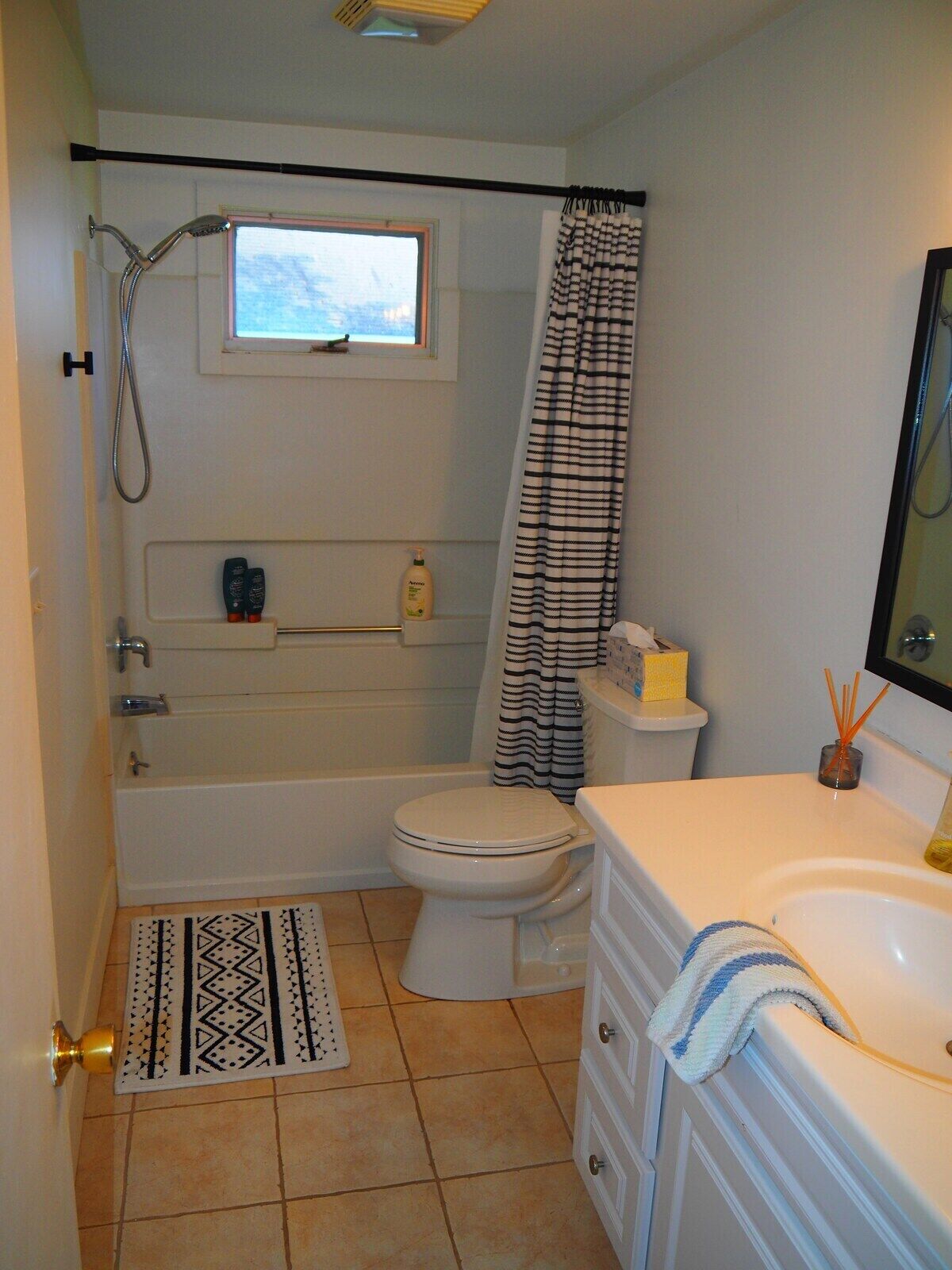 A bathroom with a bathtub, toilet, and sink.