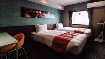 A hotel room with two beds, a desk, and a chair. There is a window with curtains, an air conditioning unit, and a painting on the wall.