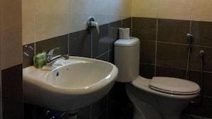 A bathroom with a sink, toilet, and a window. - Indah Garden Hotel (Ampang)