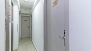 A corridor with a door marked "305" and a sign indicating no smoking. - Indah Garden Hotel (Ampang)