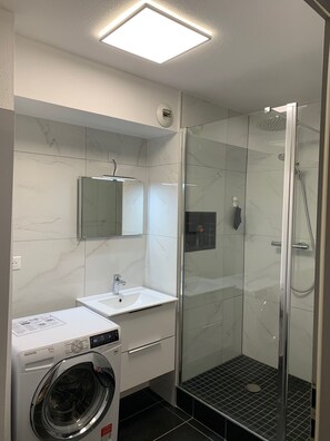 Shower, hair dryer, slippers, towels