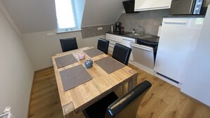 A compact kitchen with a dining table, chairs, and modern appliances. - Beautiful three room apartment. Bright, stylish, cozy (Sachsen - Borna)