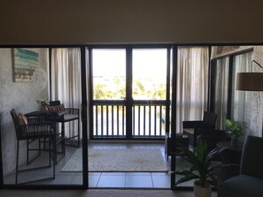 Enjoy meals and relaxation on the balcony with a dining area and comfortable seating.