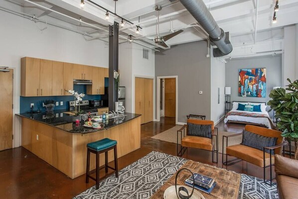 A modern apartment with a kitchen, living area, and bedroom.