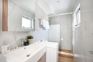 Shower, hair dryer, slippers, towels