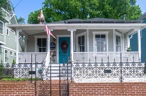 Classic two-story house with a charming front porch and decorative railing.