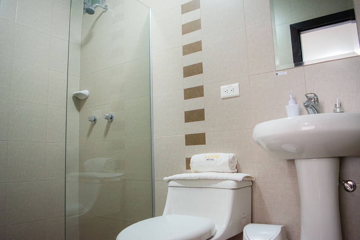 Shower, rainfall showerhead, towels, soap