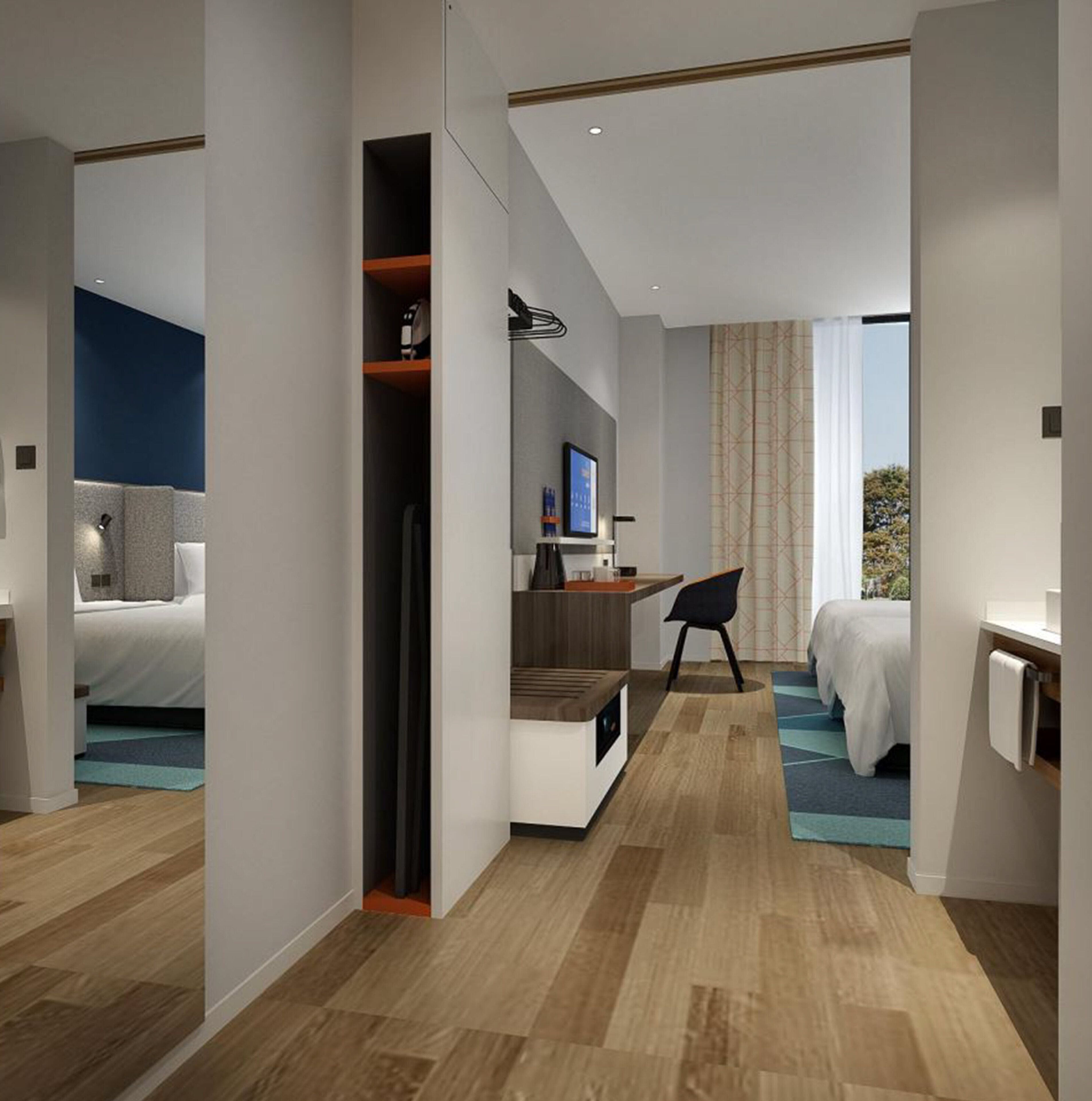 Una habitación de hotel moderna con cama, escritorio y zona de estar.