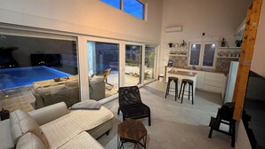 A modern living space with a pool, sliding glass doors, a kitchen, and a cozy seating area. - House on the river, private pool, garden and barbecue . 2hours to Dubrovnik! (Malo Polje)