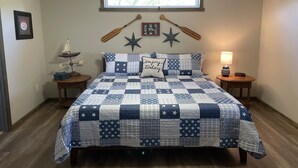 A bedroom with a bed, a ceiling fan, a window, and a nightstand with a lamp. - Sleeps 5 (unit 4b), pool, next to Big M Marina, 15 min to Roaring River (Cassville)