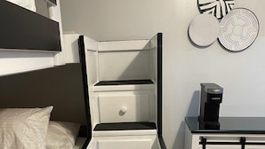 A bedroom with a bunk bed, a white bedside table with a coffee maker, and decorative wall art. - Tiny House Near Stone Mountain Park Minutes to Atlanta and FIFA.  (Lilburn)