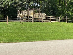 Children can play on the climbing and sliding equipment in this enclosed playground area.