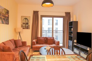 Standard Apartment | Living area | 32-inch LED TV with cable channels, TV - Furnished 1 BHK in Town Square (Dubai)
