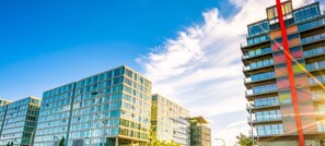 A modern building with glass facades and a prominent red vertical element. - Tattenhoe House • Great Location • Free Parking • Smart TV • Garden (Milton Keynes)