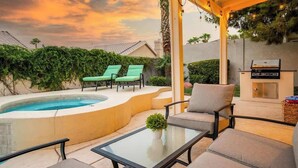 A backyard with a swimming pool, lounge chairs, a glass table, and a barbecue grill. - ❤️New 4BR/3Ba with Pool, 9 miles to LV Strip! (Henderson)