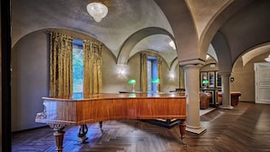 A grand lobby with a wooden reception desk, ornate curtains, and a chandelier. - Hotel Zur Post Altötting (Altötting)