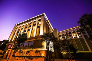A modern hotel building with multiple floors, large windows, and a well-lit facade. - Radisson Bhopal (Bhopal)