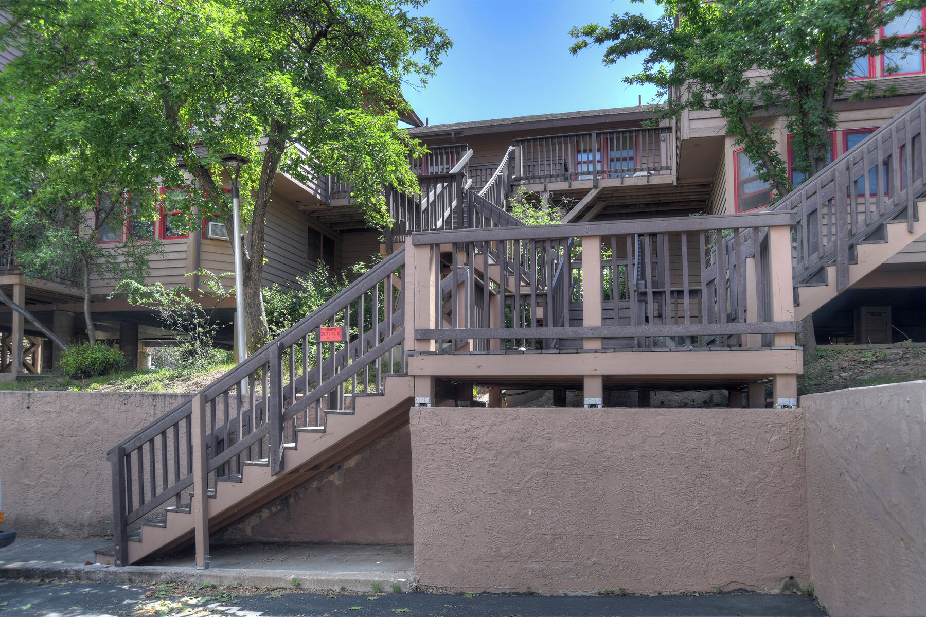 A multi-story building with a staircase leading to a balcony.